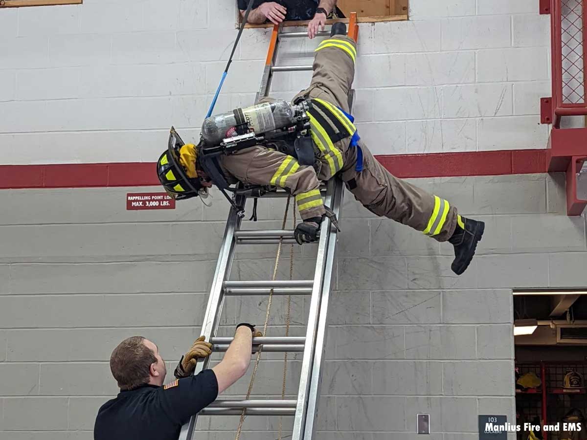 Firefighters training on a ladder